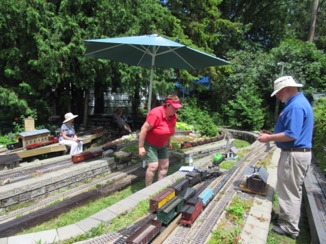 July 18.  A good view of part of the railroad: Jean rests at the top of Peter's Pond. The ore train is making its way up to Spruce. Leila and Chris are switching Ironwood. Way in the back, Stu sits near Mt St Helens.