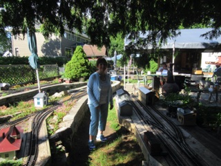 Jean and I take a walk around the layout to check everything out. Here Jean has Cedar Rock on her right, and Spruce on her left. You can just barely see the new station in Spruce (lower left).