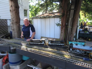July 16.  Saturday was standard gauge operations. As always, there's a bit of setup to do. Here, Jim prepares to take his locomotives out of Craig Leigh.