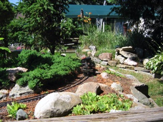 Fred claims he doesn’t really care about the garden aspect of outdoor railroading, but to the right you can see that he has done some nice work on the appearance of the layout.