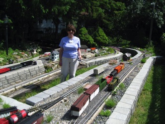 As usual, Jean is the engineer, while I act as the conductor. What this means is that Jean operates the train, controlling speed and direction. I take care of throwing the switches and uncoupling the cars. 