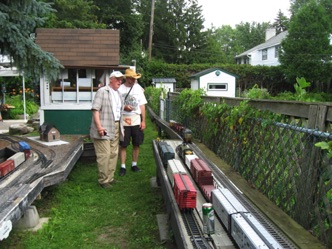 July 17.  Terry and Gaetan with their train. All in all it’s great fun and often quite challenging to figure out how you’re going to switch a particular siding, while keeping the main line clear.