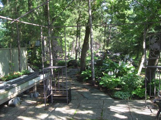 July 15.  There's progress every year, and the entrance to Doug’s garden railroad is very inviting.