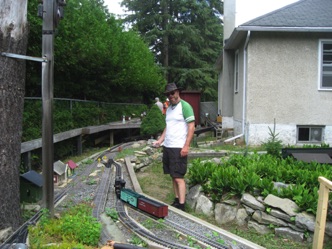July 16.  Gaètan switches his freight. In the background you can see the hole in the fence cut to extend the yard lead at Rat Portage.