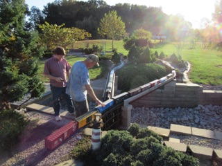 At the end of Sunday, all of the cars have to be brought back to the basement. Robbie and Ken are bringing in a couple of trains.