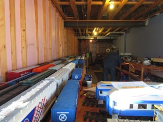 Every car is stored on racks of tracks in the basement. The shelves continue way off to the right. That's Andy trying to make sure it's all put away correctly.