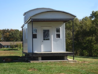 October 17.  The caboose looks great with the rivets; Jinx enjoys the shade.