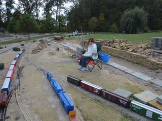 Overlook is deceptive. When you first pull in, you're convinced that there's more than enough track to switch everything without fouling the main. Later, it just doesn't seem so. Anyway, Jean is recovering from back surgery and enjoys the opportunity to take a seat while she operates the locomotives. In this shot, the main is almost out of sight on the far left, part of our train occupies the track available to us at Overlook.