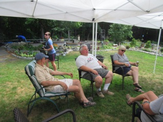 August 5.  Then it's over to Bob's for a time to socialize and informally run trains. That's Richard Beverly way back at Franklin Falls, then Maggie (Jon & Marilyn's niece). Bob, Jon, Marilyn.