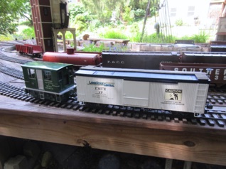 Since Friday is just "Run what you Brung" I get out my little boxcab and LSC Anniversary car to run around the layout. Here it's in Burke, with the coal tower in the left background.