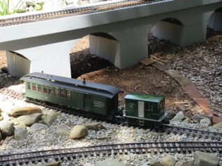 Meanwhile, I have snatched up a combine and take it around the layout, crossing under the viaduct after leaving Majestic.