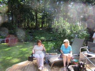 August 13.  Sunday - it's the final day of TrainOps and we head over to Chelmsford to run on Stan & Deb's S.J.R. & P. Ry. for another day of operation.
Jean and Marilyn relax on the deck at Deck.