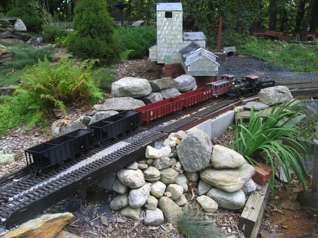 After putting the gondolas on the back of the train, we add the caboose and run around the train. 