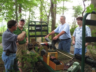 Here, Ben, Jack, Ken, and Kevin discuss some weighty topic. Note the baggage car used as a temporary storage platform. 