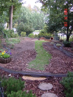 I now have a camel back bridge at the lower end, and a stone bridge near the patio.