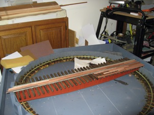 October 23, 2006.  
Next, it was time to plank the bridge. Well, first I glued and nailed the ties, spiked the rails in place, and then glued down redwood strips. I nailed these in place with very small brass ship nails. I really don't like relying on just glue alone. 