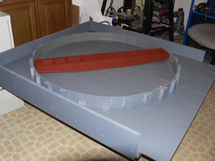 October 15, 2006.  I built up the walls using Precision Products Perfic panels cut to size and bent and glued to supporting blocks that were screwed in from underneath. I sprayed the base assembly with Krylon gray primer and the bridge with ruddy brown. 