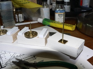 October 6, 2006.  My idea was to make this a continuous 3 point balance turntable, with wheels on each end contacting the rail. I used some brass pulleys from my scrap box along with a brass rod for an axle. These were sandwiched between two spacer blocks. 