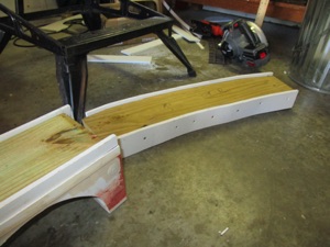 June 30.  Next up is to start on the through girder pieces. The 2x8 has been trimmed to the curve and I screw some 3/8" inch pvc to the side. The pvc is 3" high.