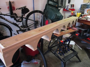 I painted the first coat on the viaduct itself. I'm sure it will look even better with two coats.

Earlier, I found some rosettes on Thingiverse; scaled them down and then printed a bunch out. Glued them in place between the arches.