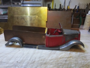 I also had some COPPER sheets that I soldered together to make a bed. Starting to look more like a firetruck, but here the project stalled out as I really couldn't figure out what to do with the inside of the body.