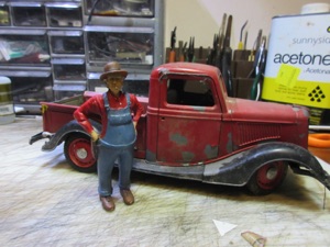 February 23, 2015.  I leave my vehicles out all year long and the weather takes its toll. So, I could strip it and repaint it, but I'm eventually planning a fire house in my town, although who knows when that will be. Why not make a firetruck? Well, it's a small pickup: a Solido 1:19 1936 Ford pickup. It doesn't really look like a firetruck. Hmm. Not that I really know what a firetruck really looks like, but that's never stopped me.
Out comes the dremel! 